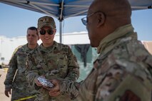 Lt. Col. Dwayne Jones, Task Force-Holloman chaplain, brings breakfast to Airmen working at Aman Omid Village in Holloman Air Force Base, New Mexico, Sept. 13, 2021. The Department of Defense, through U.S. Northern Command, and in support of the Department of State and Department of Homeland Security, is providing transportation, temporary housing, medical screening, and general support for at least 50,000 Afghan evacuees at suitable facilities, in permanent or temporary structures, as quickly as possible. This initiative provides Afghan evacuees essential support at secure locations outside Afghanistan. (U.S. Army photo by Pfc. Anthony Sanchez)