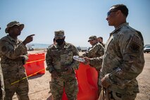 Senior Master Sgt. Aaron Waddy, Task Force-Holloman first sergeant, brings breakfast to Airmen working at Aman Omid Village in Holloman Air Force Base, New Mexico, Sept. 13, 2021. The Department of Defense, through U.S. Northern Command, and in support of the Department of State and Department of Homeland Security, is providing transportation, temporary housing, medical screening, and general support for at least 50,000 Afghan evacuees at suitable facilities, in permanent or temporary structures, as quickly as possible. This initiative provides Afghan evacuees essential support at secure locations outside Afghanistan.(U.S. Army photo by Pfc. Anthony Sanchez)