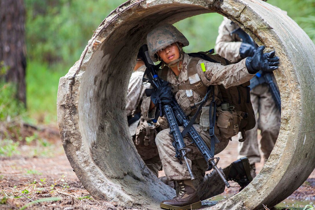 A Marine Corps recruit maneuvers through an obstacle.