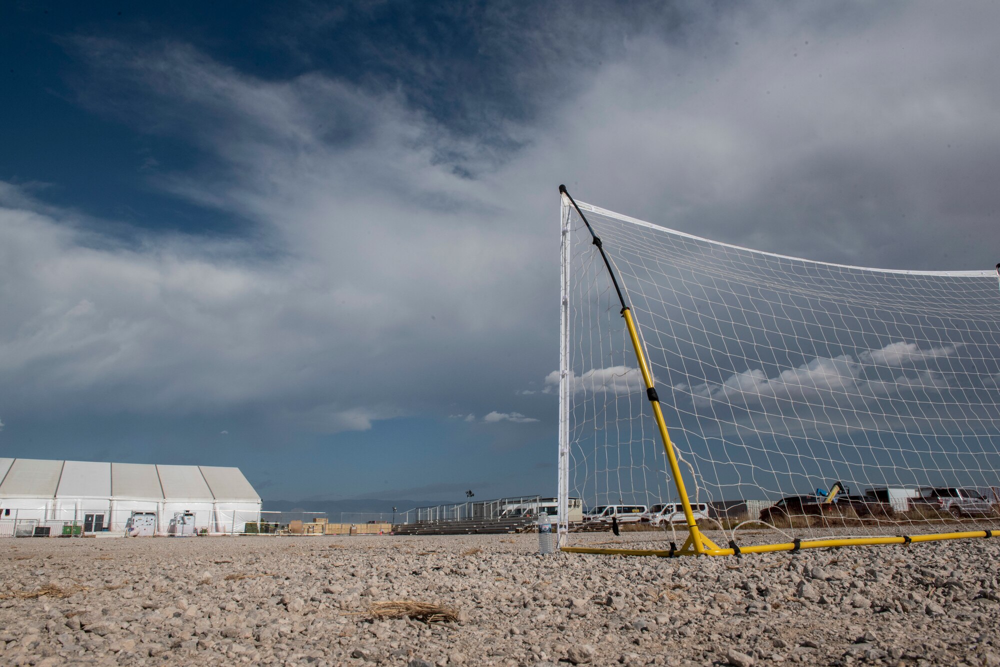 Airmen from Task Force-Holloman set up a soccer field with bleachers for the Afghan refugees at Aman Omid Village at Holloman Air Force Base, New Mexico, Sept. 6, 2021. The Department of Defense, through U.S. Northern Command, and in support of the Department of State and Department of Homeland Security, is providing transportation, temporary housing, medical screening, and general support for at least 50,000 Afghan evacuees at suitable facilities, in permanent or temporary structures, as quickly as possible. This initiative provides Afghan evacuees essential support at secure locations outside Afghanistan. (U.S. Air Force photo by Staff Sgt. Kenneth Boyton)