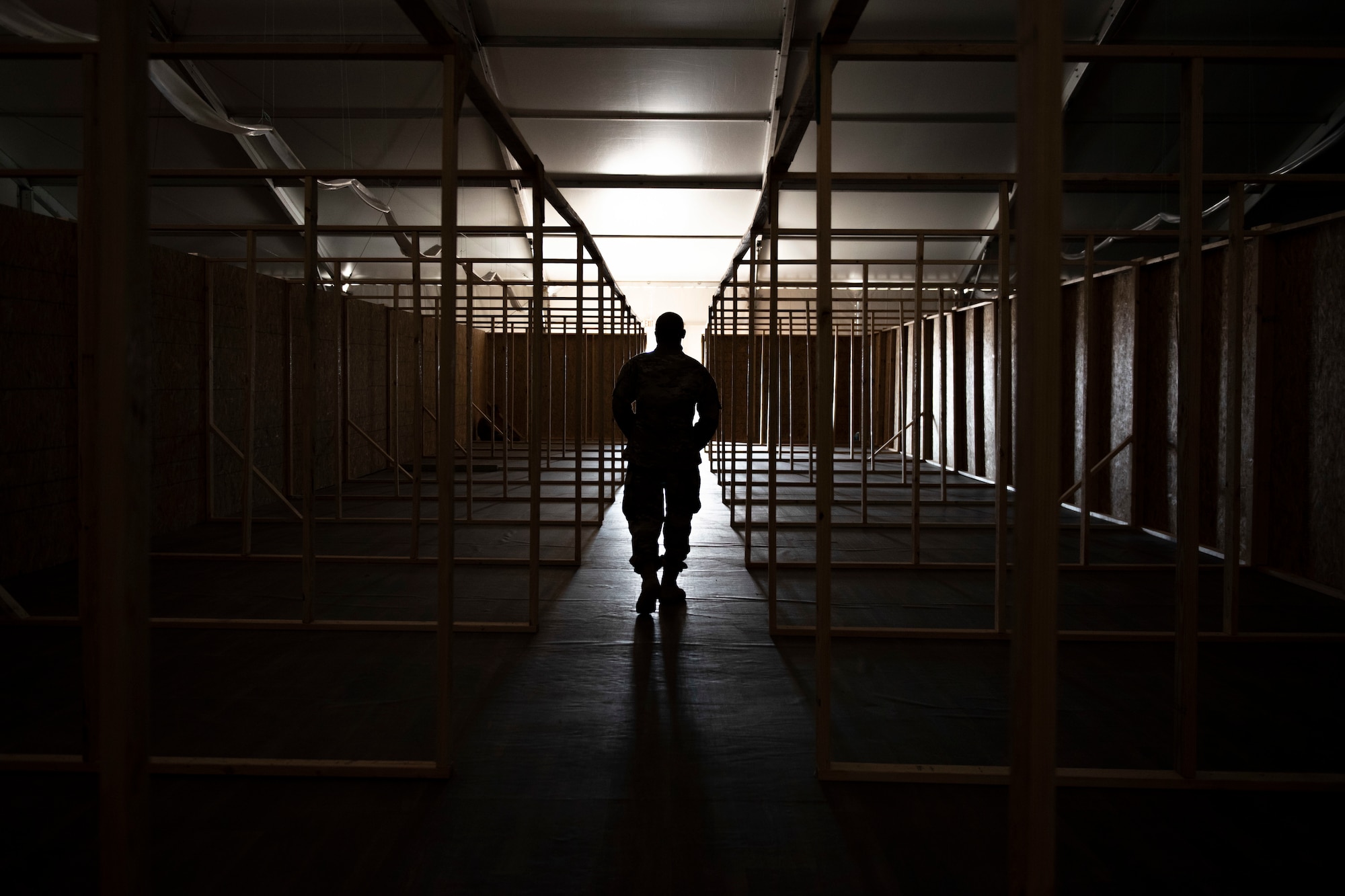 An Airman assigned to Task Force-Holloman helps build partitions in one of the Afghan evacuees living quarters at Aman Omid Village on Holloman Air Force Base, New Mexico, Sept. 6, 2021. The Department of Defense, through U.S. Northern Command, and in support of the Department of State and Department of Homeland Security, is providing transportation, temporary housing, medical screening, and general support for at least 50,000 Afghan evacuees at suitable facilities, in permanent or temporary structures, as quickly as possible. This initiative provides Afghan evacuees essential support at secure locations outside Afghanistan. (U.S. Air Force photo by Staff Sgt. Kenneth Boyton)