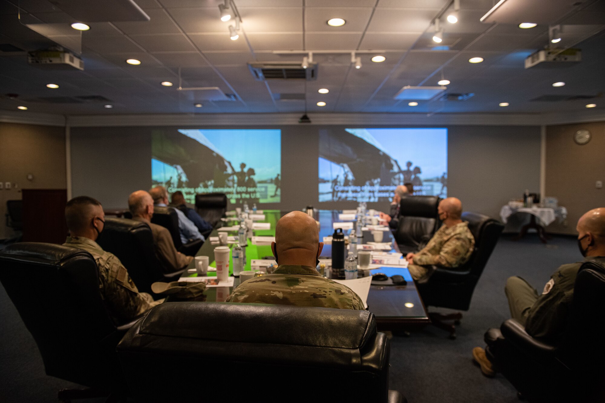 Brig. Gen. Daniel Gabrielli, center, Task Force-Holloman commander, local city mayors, and a leader from the Mescalero Tribal Community, watch a mission video about TF-H and the work they’ve done in support of Operation Allies Welcome at Holloman Air Force Base, New Mexico, Sept. 9, 2021. The Department of Defense, through U.S. Northern Command, and in support of the Department of State and Department of Homeland Security, is providing transportation, temporary housing, medical screening, and general support for at least 50,000 Afghan evacuees at suitable facilities, in permanent or temporary structures, as quickly as possible. This initiative provides Afghan evacuees essential support at secure locations outside Afghanistan. (U.S. Air Force photo by Staff Sgt. Kenneth Boyton)