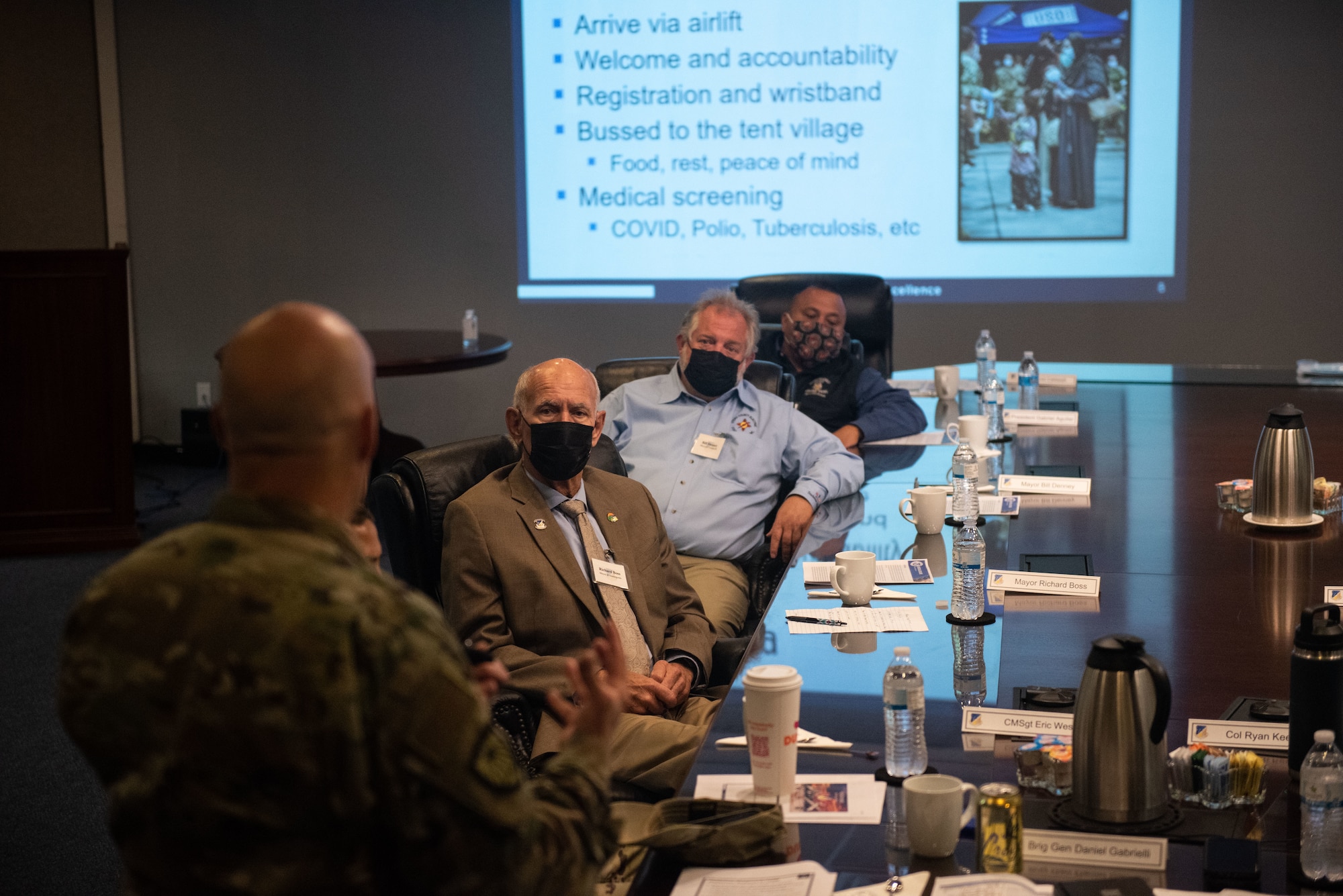 Brig. Gen. Daniel Gabrielli, left, Task Force-Holloman commander, speaks with local city mayors, and a leader from the Mescalero Tribal Community, about the mission of TF-H and their accomplishments at Holloman Air Force Base, New Mexico, Sept. 9, 2021. The Department of Defense, through U.S. Northern Command, and in support of the Department of State and Department of Homeland Security, is providing transportation, temporary housing, medical screening, and general support for at least 50,000 Afghan evacuees at suitable facilities, in permanent or temporary structures, as quickly as possible. This initiative provides Afghan evacuees essential support at secure locations outside Afghanistan. (U.S. Air Force photo by Staff Sgt. Kenneth Boyton)