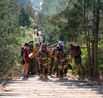 MANITOU SPRINGS, Colo. –Firefighters climb the steps of the Manitou Incline in Manitou Springs, Colorado, on the 20th Anniversary of 9/11, Sept. 11, 2021. The firefighters have traditionally carried up the U.S. flag along with a flag with all the names of first responders who lost their lives in the Sept. 11 attacks. (U.S. Space Force photo by Staff Sgt. Alexandra M. Longfellow)