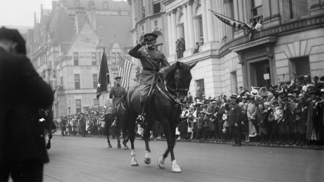 Military officer on horseback participates in parade