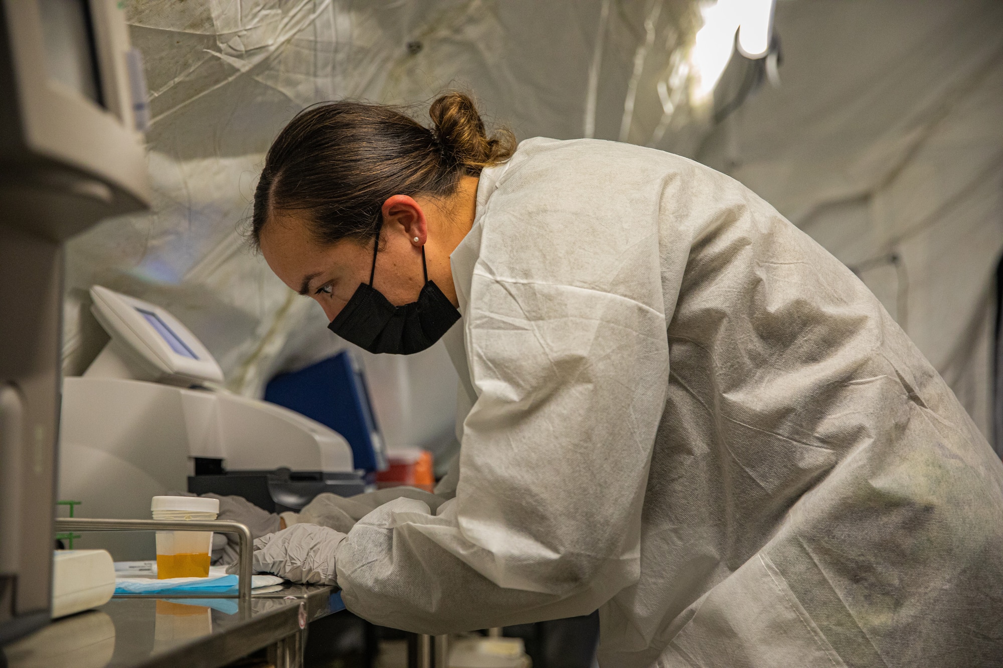 An Expeditionary Medical Support System Airman attached to Task Force-Holloman analyzes a urine sample in support of Operation Allies Welcome at Holloman Air Force Base, New Mexico, Sept. 10, 2021. The Department of Defense, through U.S. Northern Command, and in support of the Department of State and Department of Homeland Security, is providing transportation, temporary housing, medical screening, and general support for at least 50,000 Afghan evacuees at suitable facilities, in permanent or temporary structures, as quickly as possible. This initiative provides Afghan evacuees essential support at secure locations outside Afghanistan. (U.S. Army photo by Pfc. Anthony Sanchez)