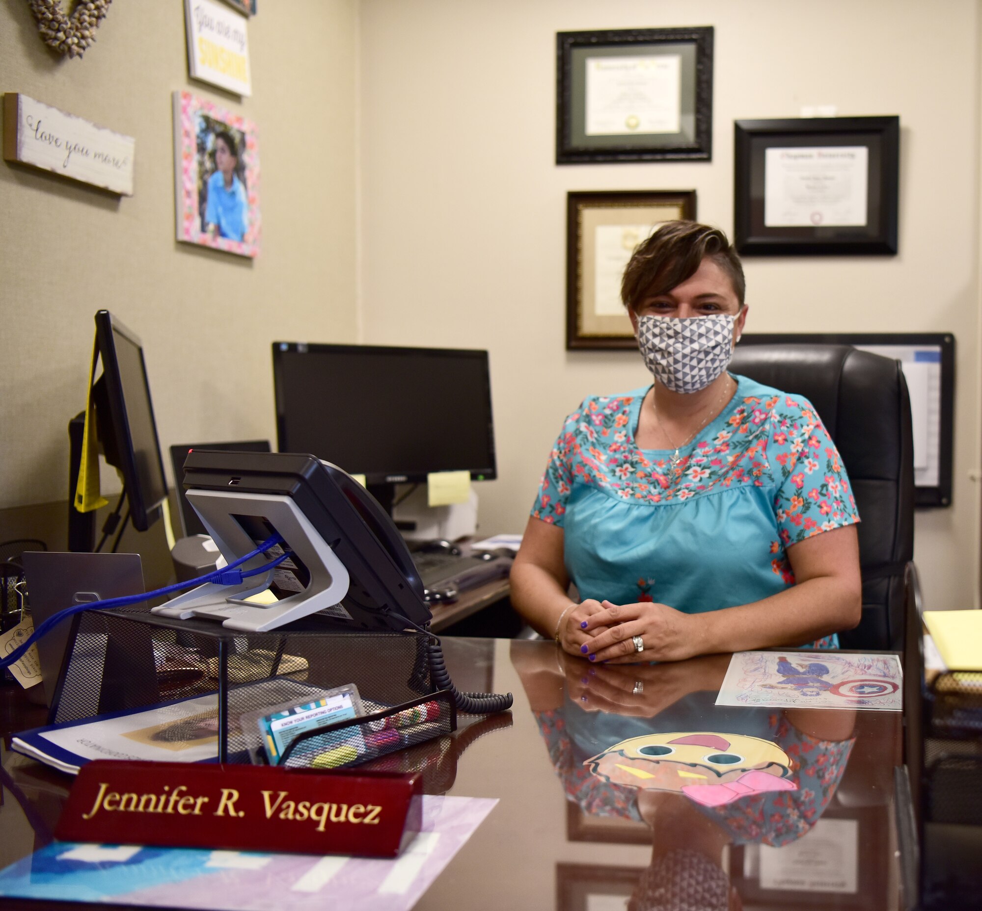 Mrs. Jennifer R. Vasquez, Victim Awareness Assistance Program Coordinator at Space Launch Delta 30 on Vandenberg Space Force Base, sits at her desk August 18, 2021. Vasquez explained her daily work schedule with her co-workers and clients that come to her for legal help. (U.S. Space Force photo by Airman First Class Tiarra Sibley)