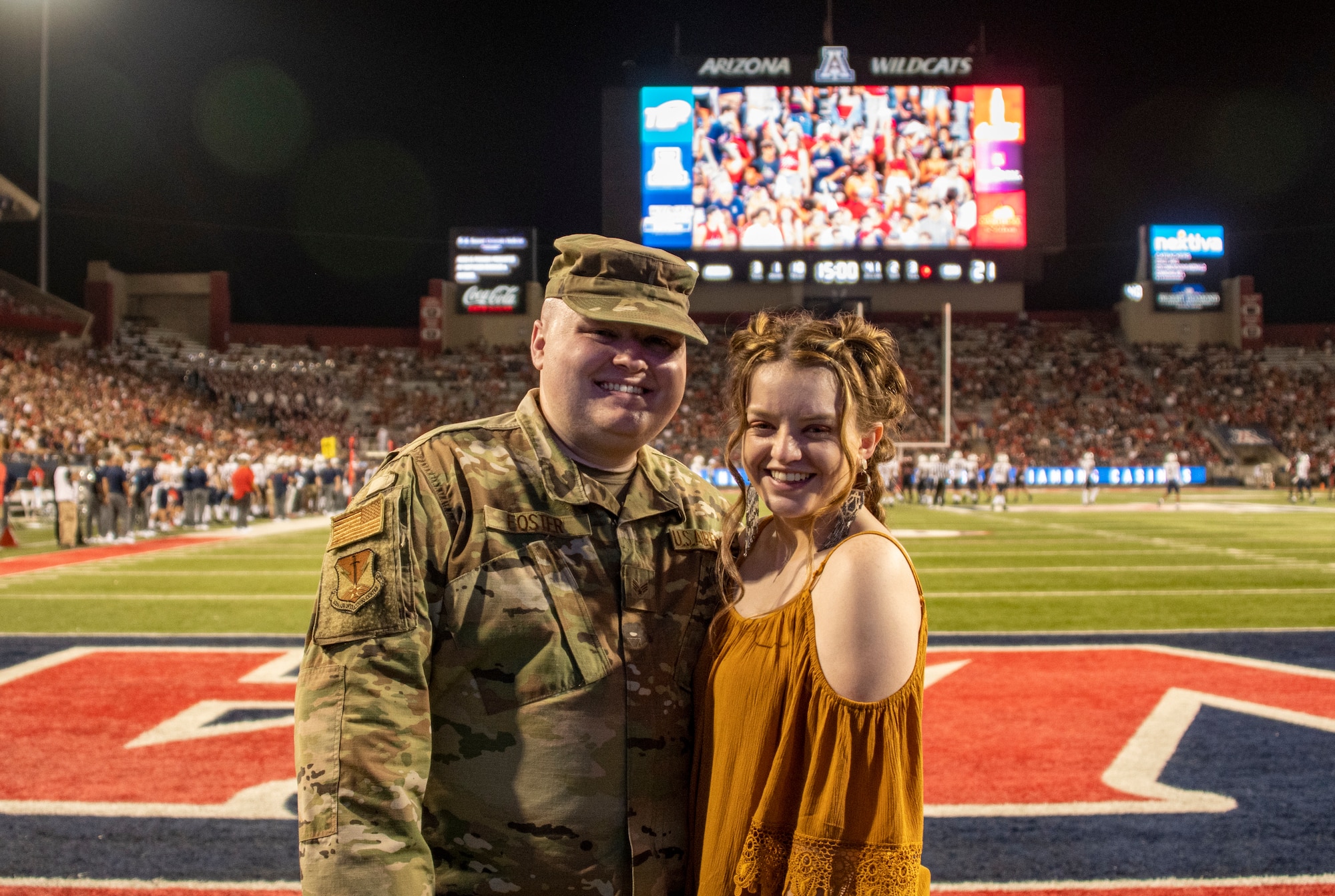 A photo of the hometown hero with his wife posing for the camera.