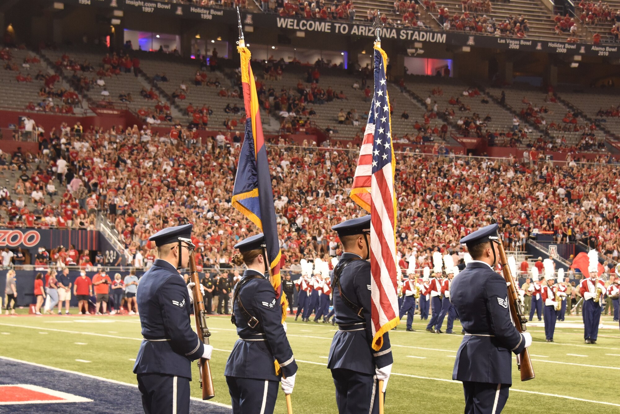A picture of honor guard presenting the colors at a University of Arizona football game.