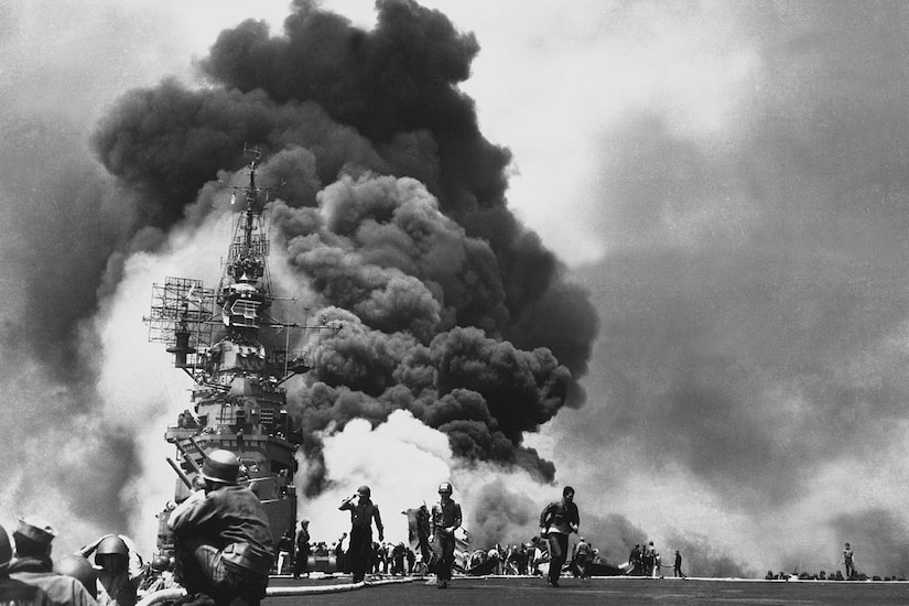 An aircraft carrier goes up in smoke.