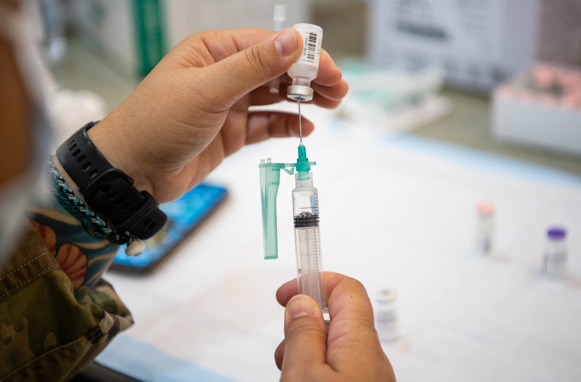 1st Lt. Stephanie Licup, 15th Medical Group registered nurse, reconstitutes a Pfizer vaccine at the Hickam Gymnasium at Joint Base Pearl Harbor-Hickam, Hawaii, Sept. 8, 2021. Each frozen vile was reconstituted by adding sodium chloride, enabling the administration of six doses from each vial. (U.S. Air Force photo by Senior Airman Alan Ricker)