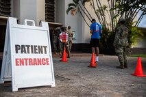 Active-duty Air Force members complete an initial screener before entering the Hickam Gymnasium for COVID-19 vaccinations at Joint Base Pearl Harbor-Hickam, Hawaii, Sept. 8, 2021. Vaccines were prepared and administered in the gym by medical personnel for approximately 13 hours. (U.S. Air Force photo by Senior Airman Alan Ricker)