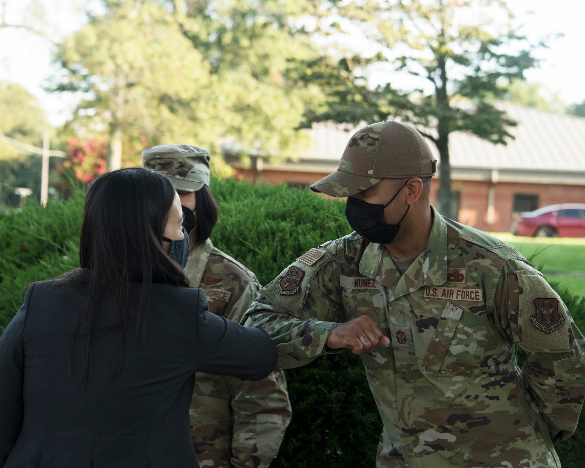 Under Secretary of the Air Force Gina Ortiz Jones greets Chief Master Sgt. Israel Nunez, 459th Air Refueling Wing Command Chief, as she prepares for a meeting with 459th ARW Airmen, Sept. 11, 2021, at Joint Base Andrews, Md. The USecAF traveled to Joint Base Andrews to meet with wing level leaders to discuss mandatory COVID vaccination efforts. (U.S. Air Force photo by Tech Sgt. Brent Skeen/Released)