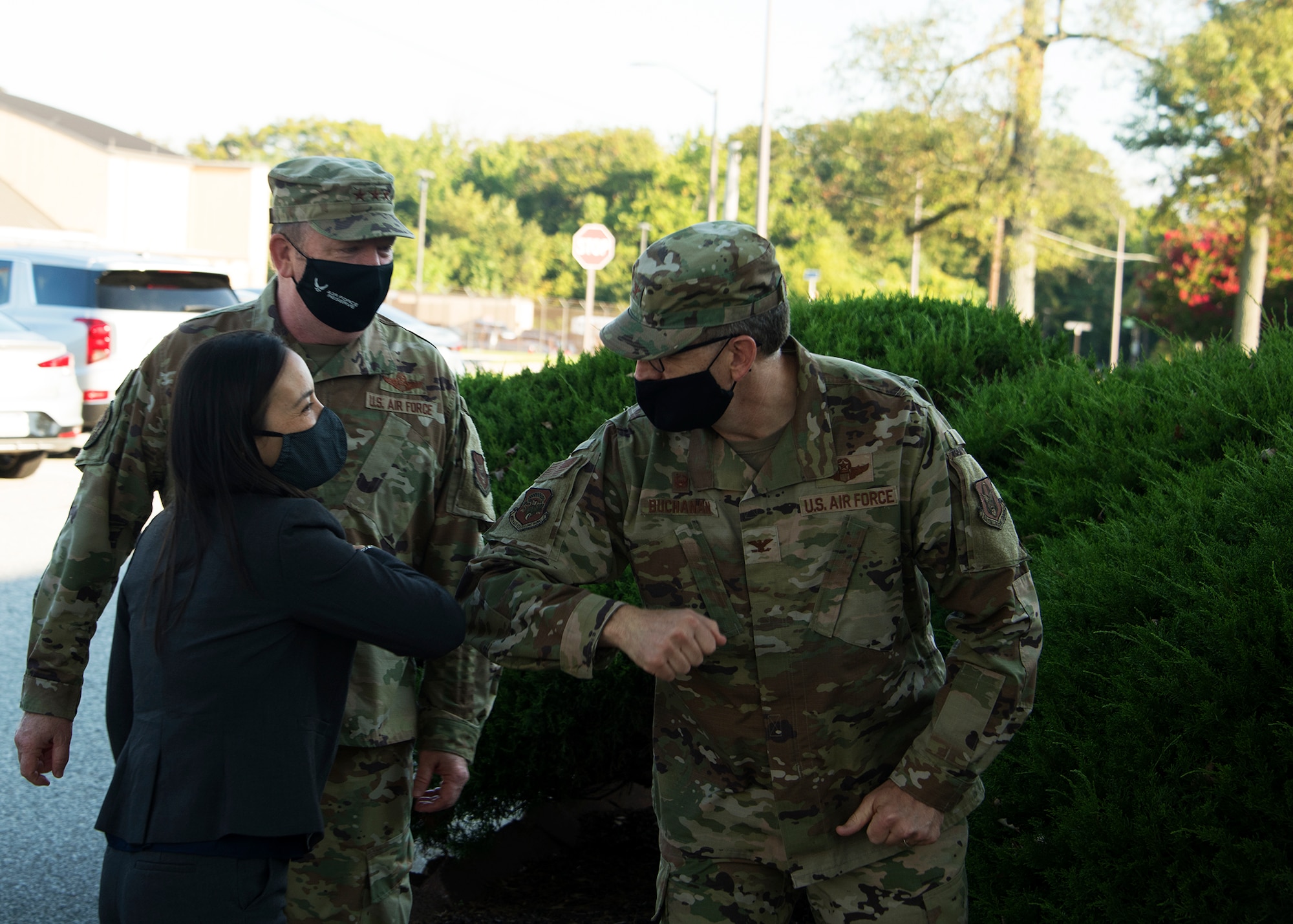 Under Secretary of the Air Force Gina Ortiz Jones greets Col. Greg Buchanan, 459th Air Refueling Wing Commander, as she prepares for a meeting with 459th ARW Airmen, Sept. 11, 2021, at Joint Base Andrews, Md. The USecAF wants to determine any limiting factors in the execution of the timeline, concerns voiced from members of the units, use of medical or religious exemptions, and best practices of communicating the safety and effectiveness of the vaccine, and show support for the units overall readiness efforts. (U.S. Air Force photo by Staff Sgt. Cierra Presentado/Released)