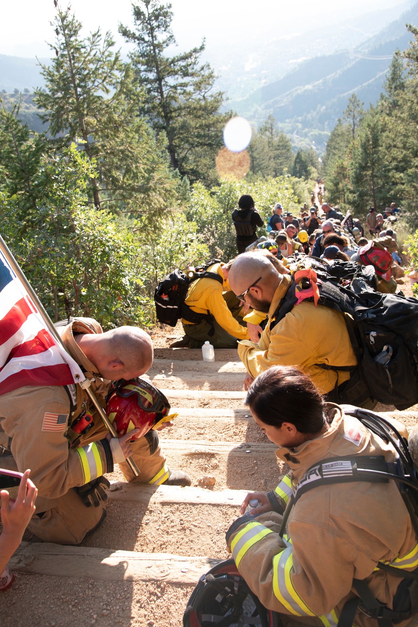 Firefighters kneel on the Manitou Incline