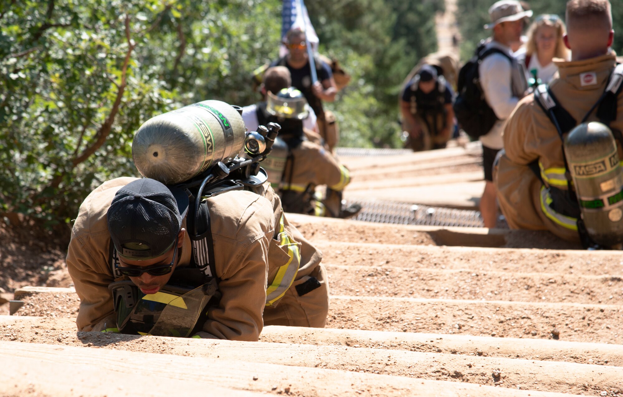 A Cheyenne Mountain Space Force Station firefighter rests during his climb up the Manitou Incline.