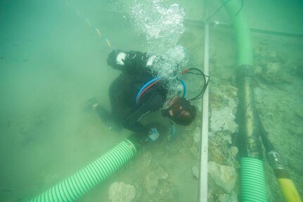 A diver searches the sea floor.