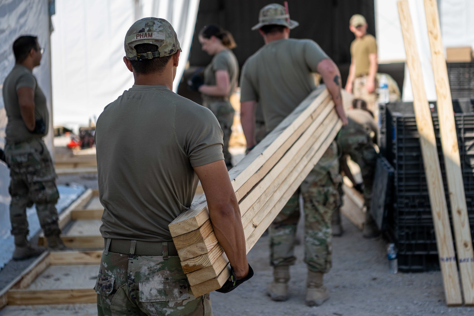 Airmen attached to Task Force-Holloman build housing for Afghan personnel in support of Operation Allies Welcome on Aman Omid Village at Holloman Air Force Base, New Mexico, Sept. 13, 2021. The Department of Defense, through U.S. Northern Command, and in support of the Department of State and Department of Homeland Security, is providing transportation, temporary housing, medical screening, and general support for at least 50,000 Afghan evacuees at suitable facilities, in permanent or temporary structures, as quickly as possible. This initiative provides Afghan evacuees essential support at secure locations outside Afghanistan. (U.S. Air Force photo by Senior Airman Skyler Combs)