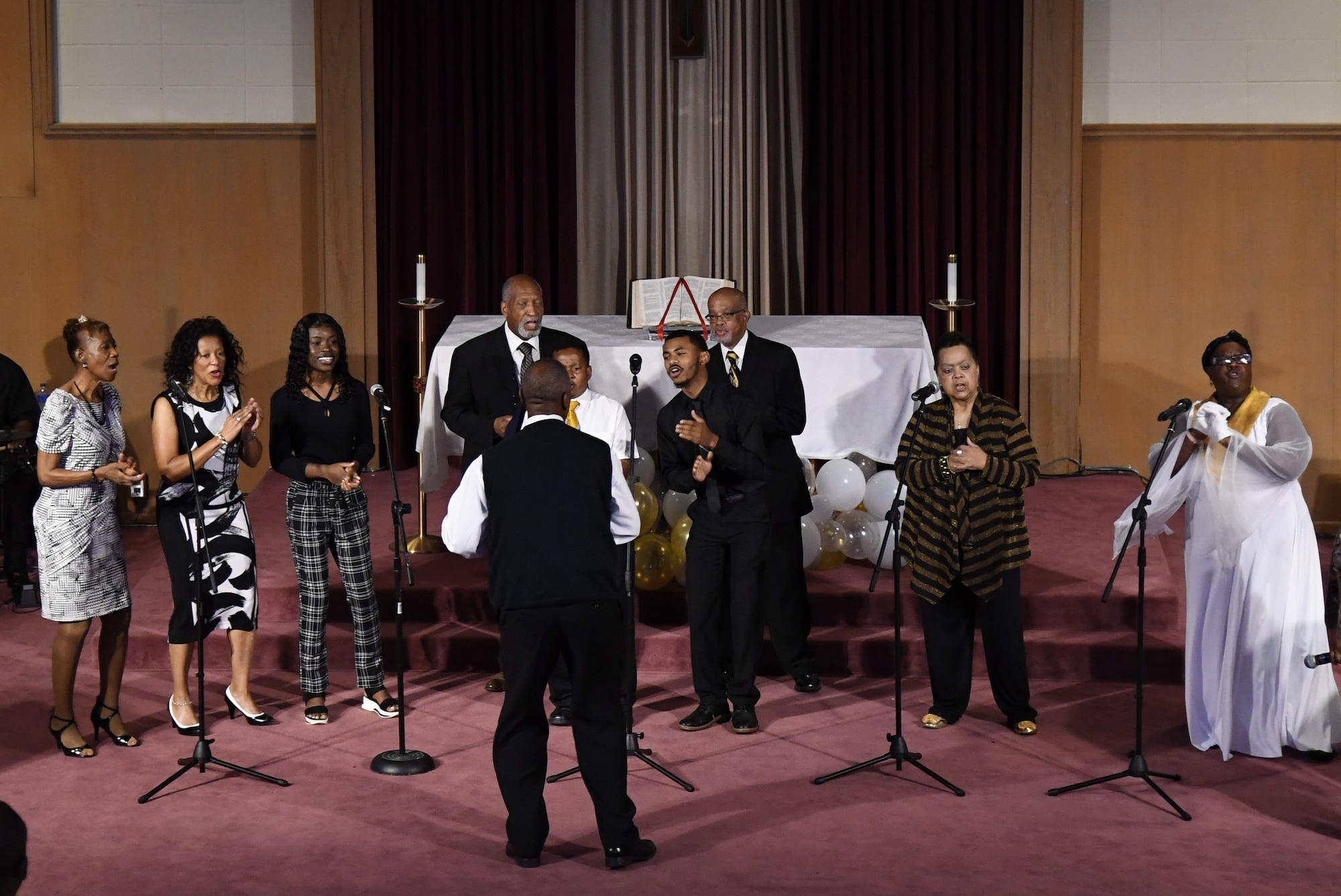 Minister Dennis Thompson leads the Gospel Choir in a song during the 50th Gospel Worship Service Anniversary inside Larcher Chapel at Keesler Air Force Base, Mississippi, Sept. 12, 2021. The service's theme was "Growing Stronger, Growing Deeper, Reaching Higher." (U.S. Air Force photo by Kemberly Groue)