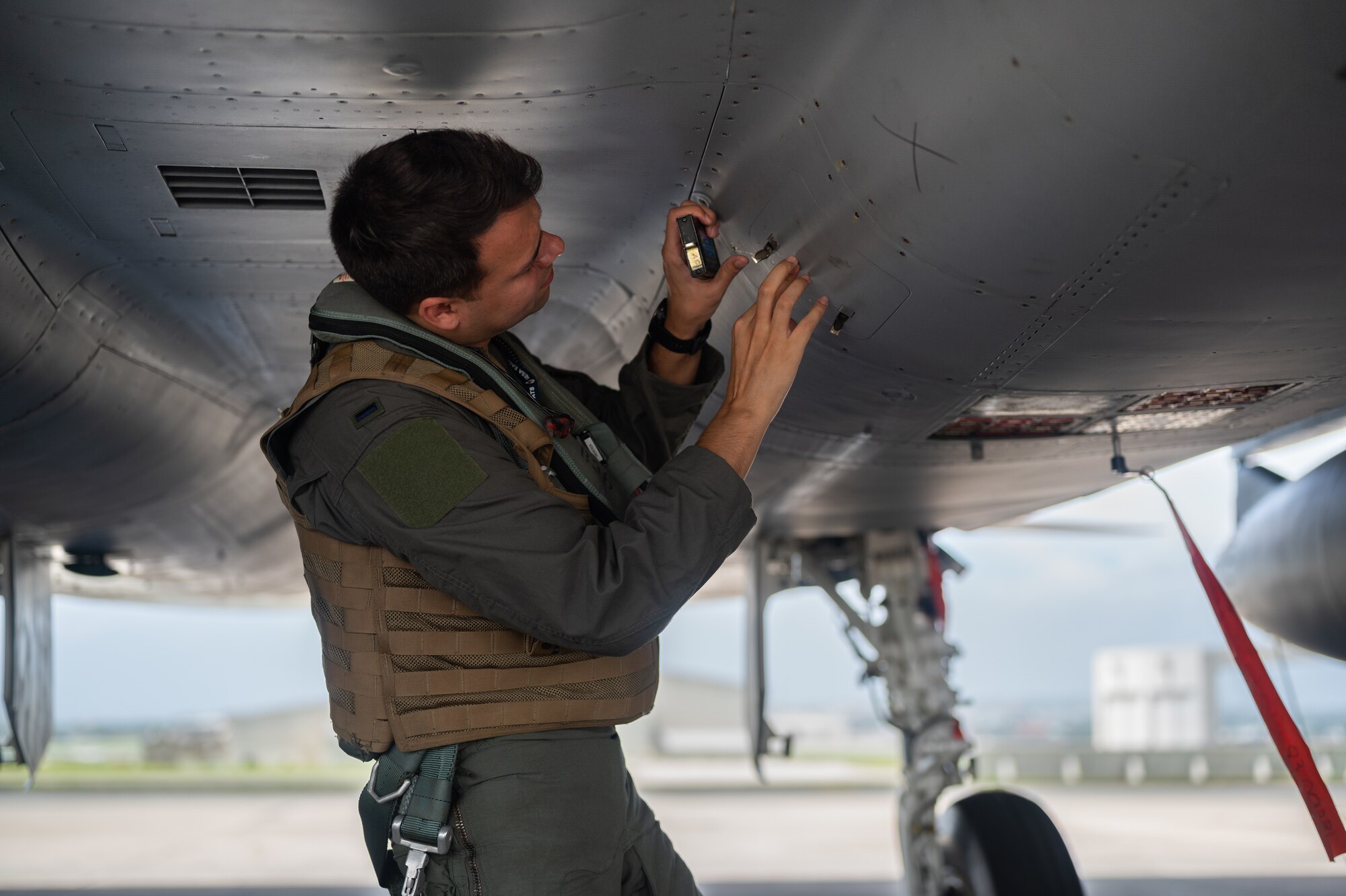 U.S. Air Force 1st Lt. Sebastian Coburn, 44th Fighter Squadron F-15C Eagle pilot, inspects an F-15C Eagle at Kadena Air Base, Japan, Sept. 14, 2021. The F-15C’s superior maneuverability and acceleration are achieved through high engine thrust-to-weight ratio and low wing-loading. (U.S. Air Force photo by Airman 1st Class Stephen Pulter)