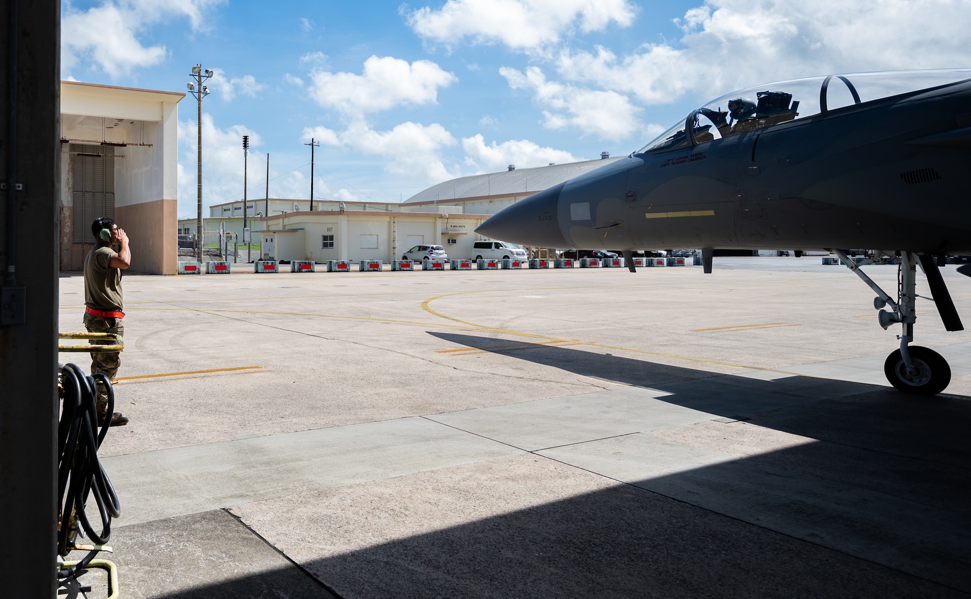 U.S. Air Force Airman 1st Class Joel Hernandez, 67th Aircraft Maintenance Unit crew chief, salutes the pilot of an F-15C Eagle at Kadena Air Base, Japan, Sept. 14, 2021. Dedicated crew chiefs are assigned to a single aircraft and are responsible for ensuring the successful completion of the aircraft’s maintenance. (U.S. Air Force photo by Airman 1st Class Stephen Pulter)