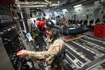 Tech. Sgt. Brandon Ducosin, 204th Airlift Squadron loadmaster, accesses C-17 Globemaster III controls Sept. 9, 2021, at Moffett Federal Airfield, Calif. A Hawaii Air National Guard aircrew flew to California to validate their ability to train alongside Guardian Angel pararescue jumpers from the 131st Rescue Squadron. The combined participants form a Personnel Recovery Task Force that can aid splashed down astronauts far into the Pacific and Atlantic oceans.