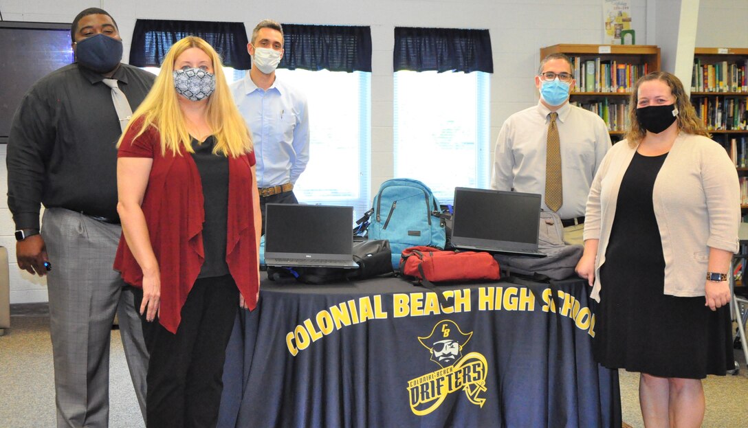 IMAGE: COLONIAL BEACH, Va. – Naval Surface Warfare Center Dahlgren Division (NSWCDD) donates 10 laptop computers with carrying cases to Colonial Beach Public Schools. In attendance to present and receive the donation is Colonial Beach Public Schools Superintendent Dr. Dashan Turner, NSWCDD Chief of Staff Terri Gray, NSWCDD Director of Collaborative Innovation Kyle Lackinger, Colonial Beach Interim High School Principal Dan Styer and Colonial Beach Public Schools Director of Technology Sarah Walker. (pictured left to right)