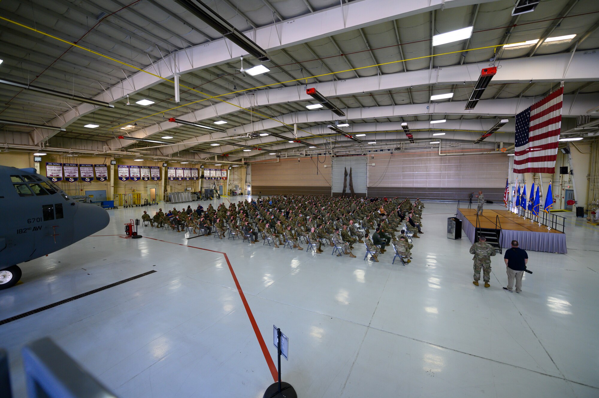 Airmen assembled in hangar.