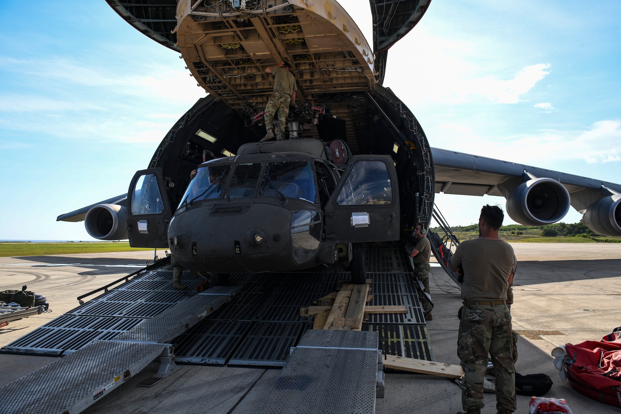 Soldiers load an UH-60 Black Hawk helicopter into a C-5 Super Galaxy.