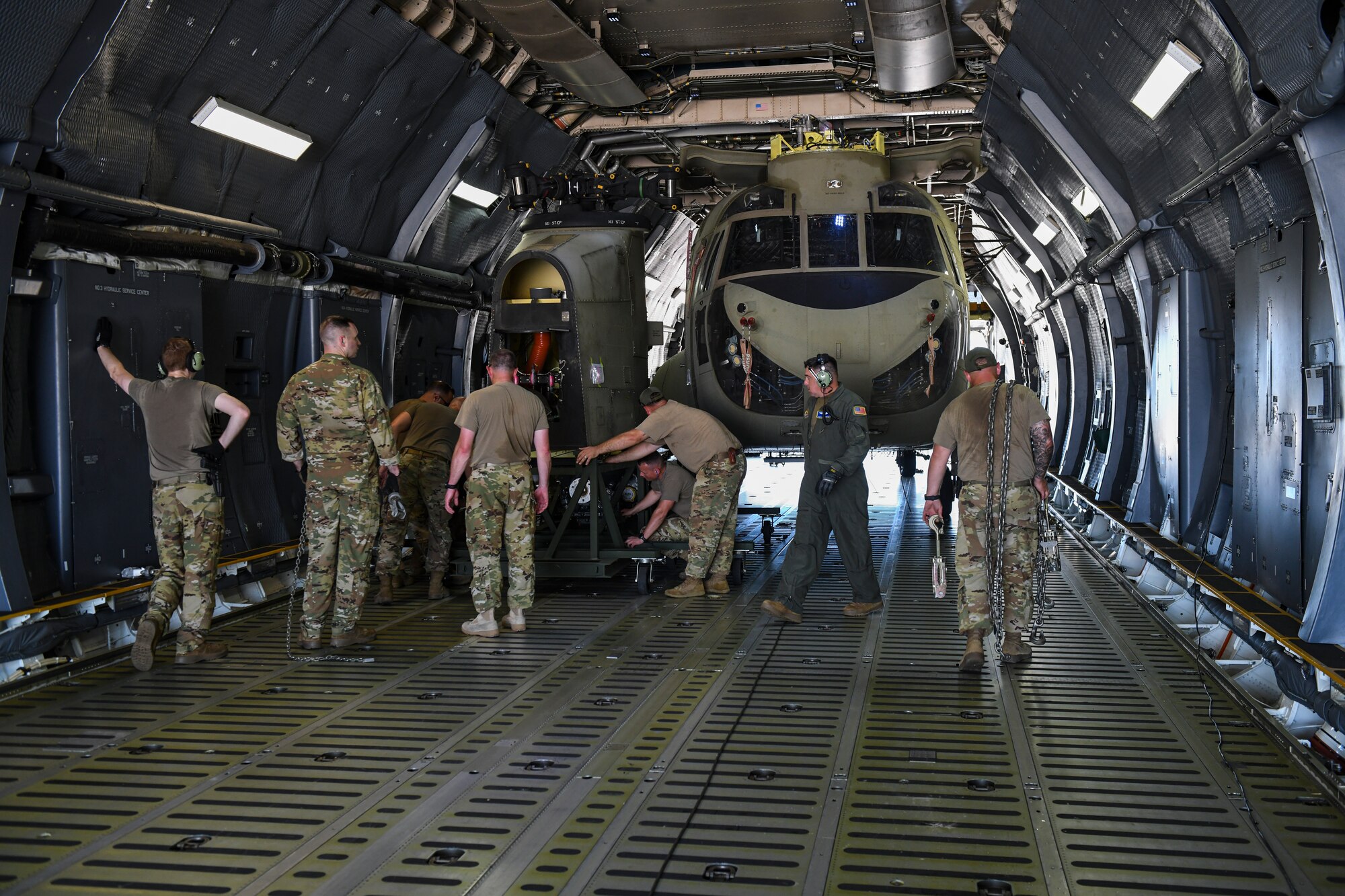Photo of soldiers loading a CH-47 Chinook into the back of a C-5 Super Galaxy.