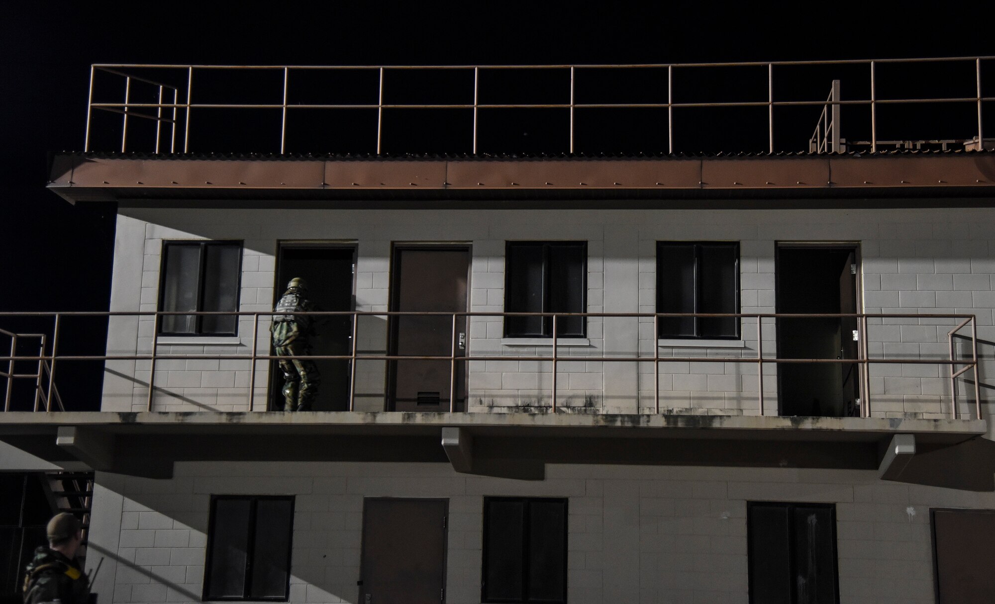 An Airman from the 51st Security Forces Squadron is observed entering a building during a routine training event