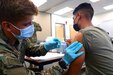 Spc. Tyler Boyer, a Hayden, Colorado native and medical specialist assigned to the 1st Stryker Brigade Combat Team, 4th Infantry Division, administers the COVID-19 vaccine at Fort Carson, Colorado Aug 3, 2021. The 4th Inf. Div. remains committed to keeping the Fort Carson community safe and healthy by offering mobile vaccinations centers.