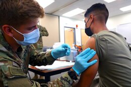 Spc. Tyler Boyer, a Hayden, Colorado native and medical specialist assigned to the 1st Stryker Brigade Combat Team, 4th Infantry Division, administers the COVID-19 vaccine at Fort Carson, Colorado Aug 3, 2021. The 4th Inf. Div. remains committed to keeping the Fort Carson community safe and healthy by offering mobile vaccinations centers.