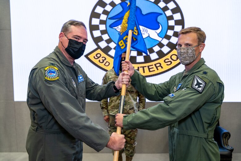 Incoming 93rd Fighter Squadron Commander, Lt. Col. David J. Sproehnle, right, receives unit guidon from Col. Craig R. Simmons, Commander of the 482nd Operations Group during a change of command ceremony, at Homestead Air Reserve Base, Fla., Sept, 12, 2021. (U.S. Air Force photo by Tech. Sgt. Lionel Castellano)