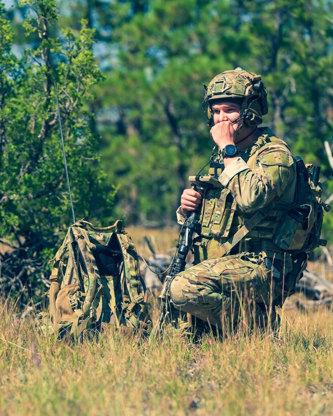 Airman sitting down talking on radio