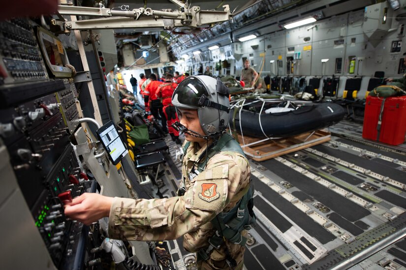 An airmen touches controls.