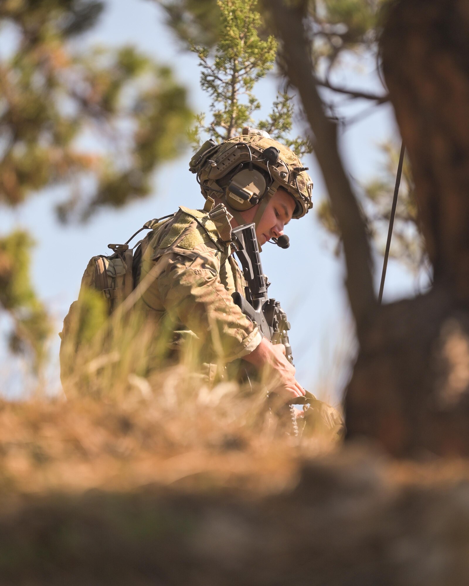 Airman sitting down talking on radio