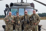 Left to right, U.S. Army Chief Warrant Officer 3 Albert Sbarro, Staff Sgt. Anthony Marotta, Sgt. 1st Class Timothy Witts, and Chief Warrant Officer 3 Quentin Hastings in front of their UH-60L Black Hawk helicopter at the New Jersey National Guard's Army Aviation Support Facility on Joint Base McGuire-Dix-Lakehurst, N.J., Sept. 14, 2021. They are part of a five-man crew that rescued nine people after catastrophic flooding in northern New Jersey from the remnants of Hurricane Ida.