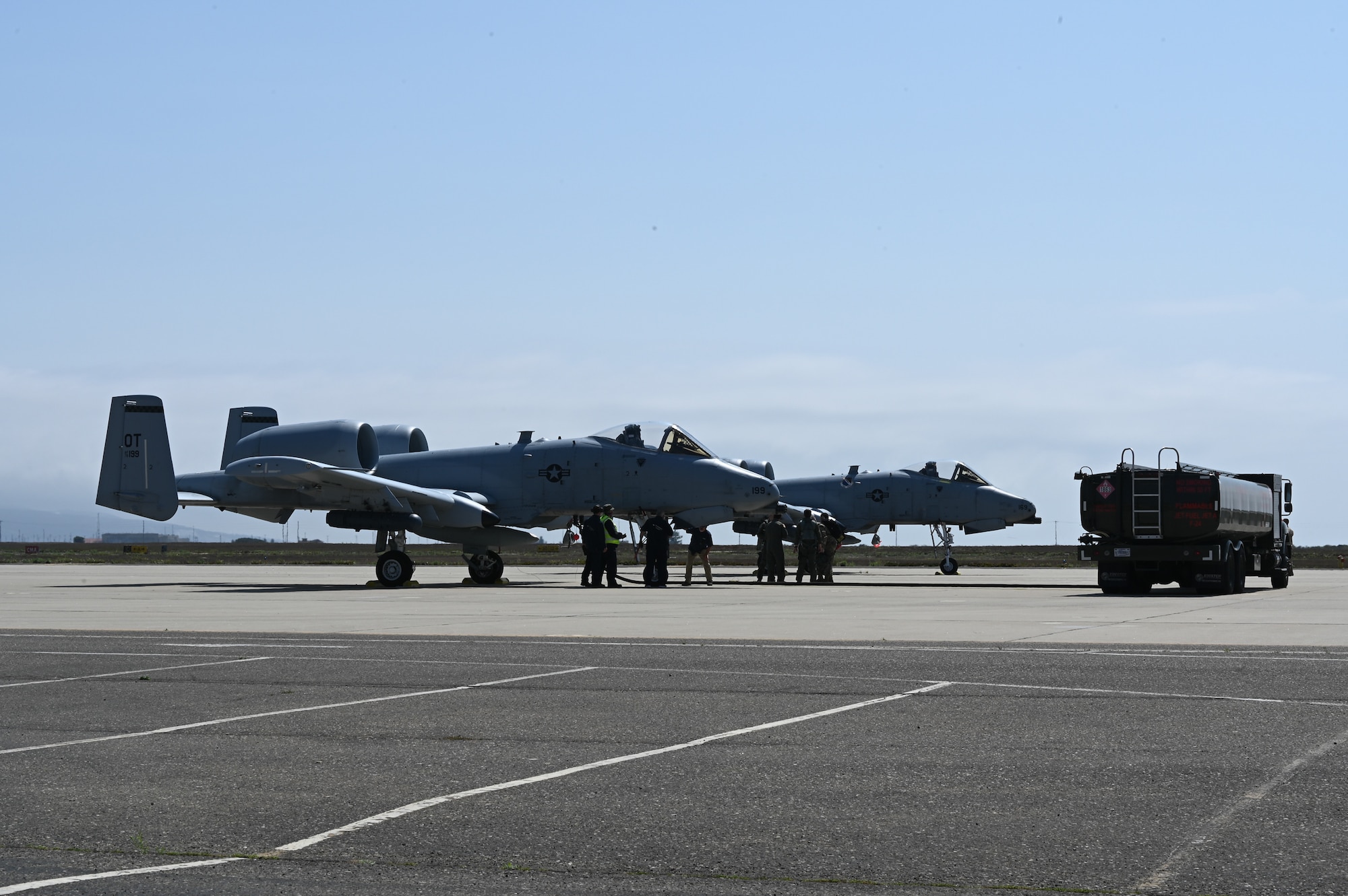 Two A-10 aircraft and a refueling truck