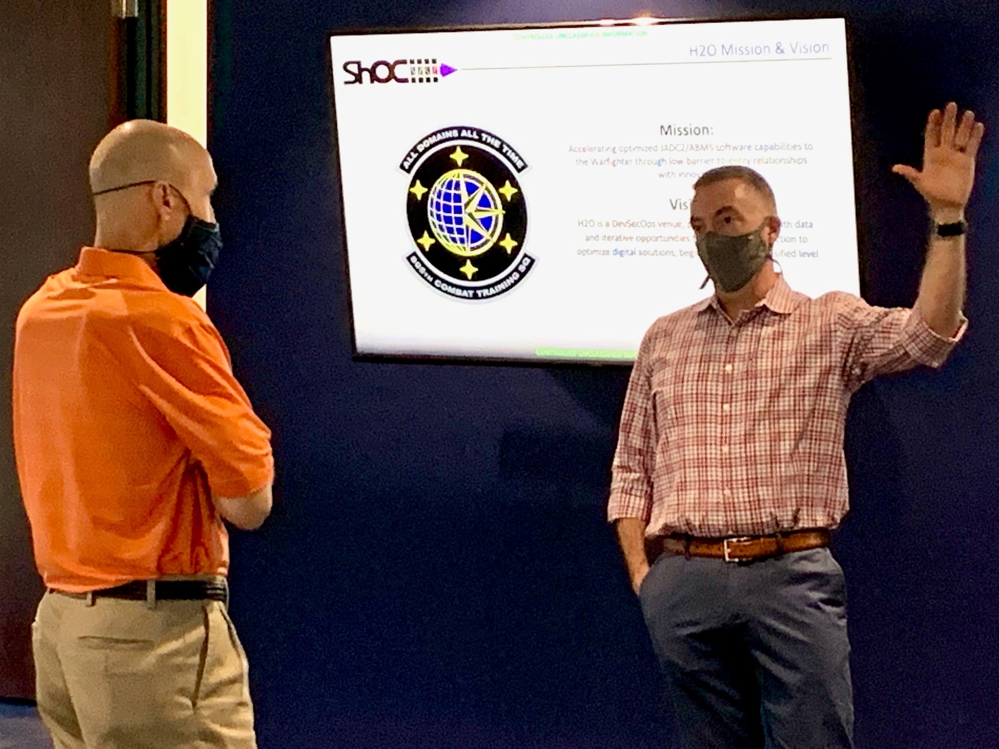 Two men standing in front of a whiteboard