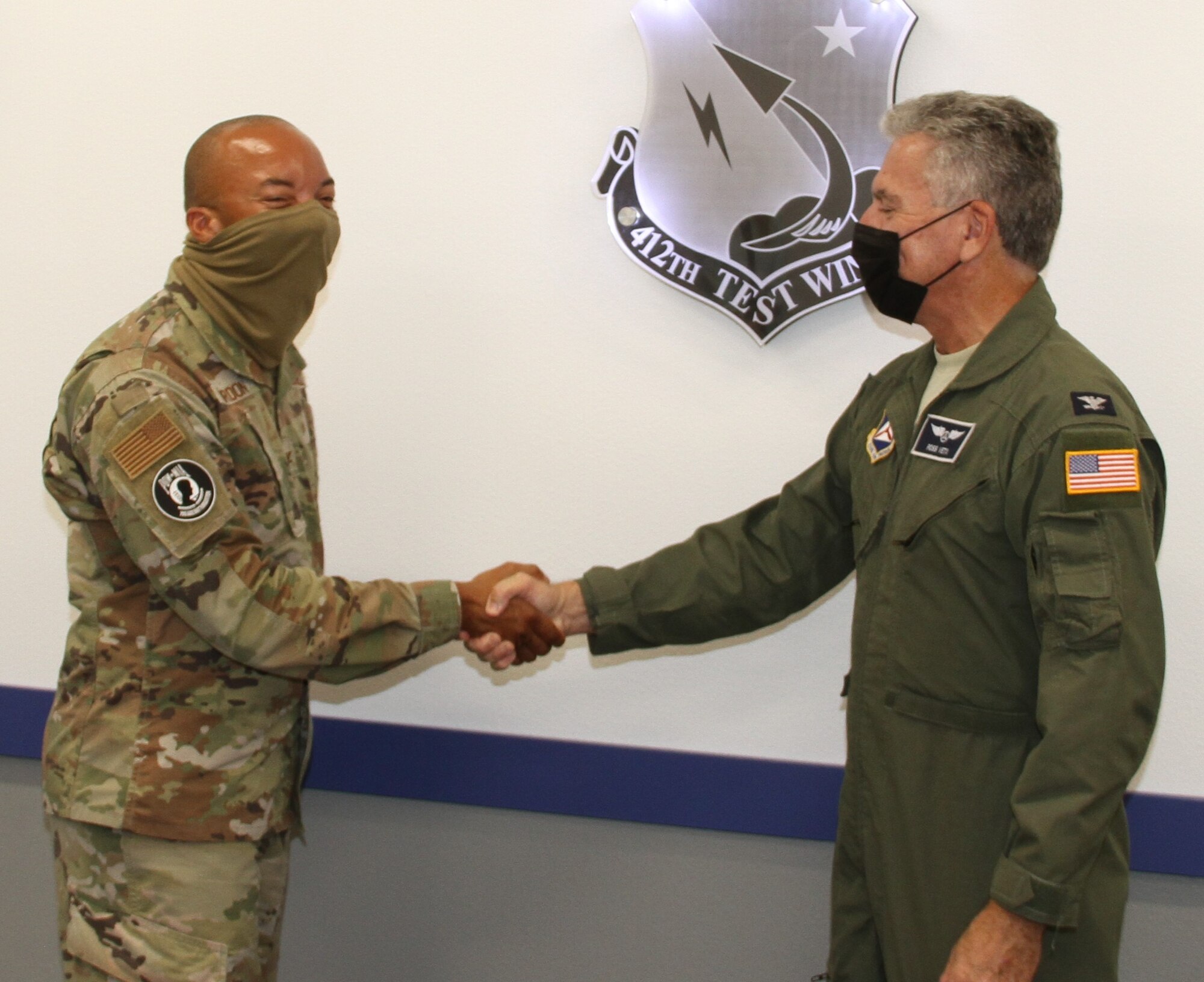ol. Randall Gordon (left), vice commander, 412th Test Wing, shakes hands with Col. Ross Veta, California Wing commander