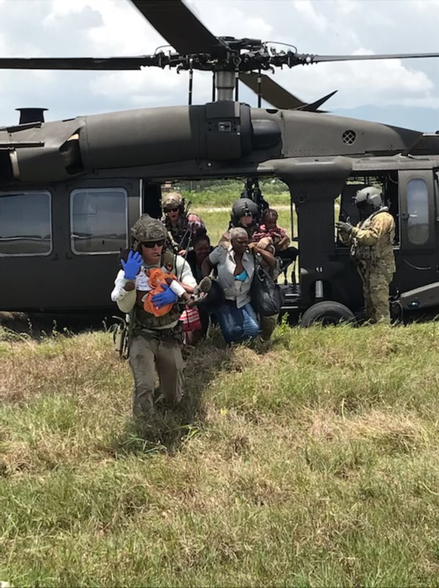 U.S. Air Force Special Tactics operator prepares to hand off an injured patient after an emergency medical evacuation in the western part of Haiti. Special Tactics Airmen responded to a request to augment Joint Task Force-Haiti relief efforts after a 7.2 magnitude earthquake hit the country Aug. 14, 2021.