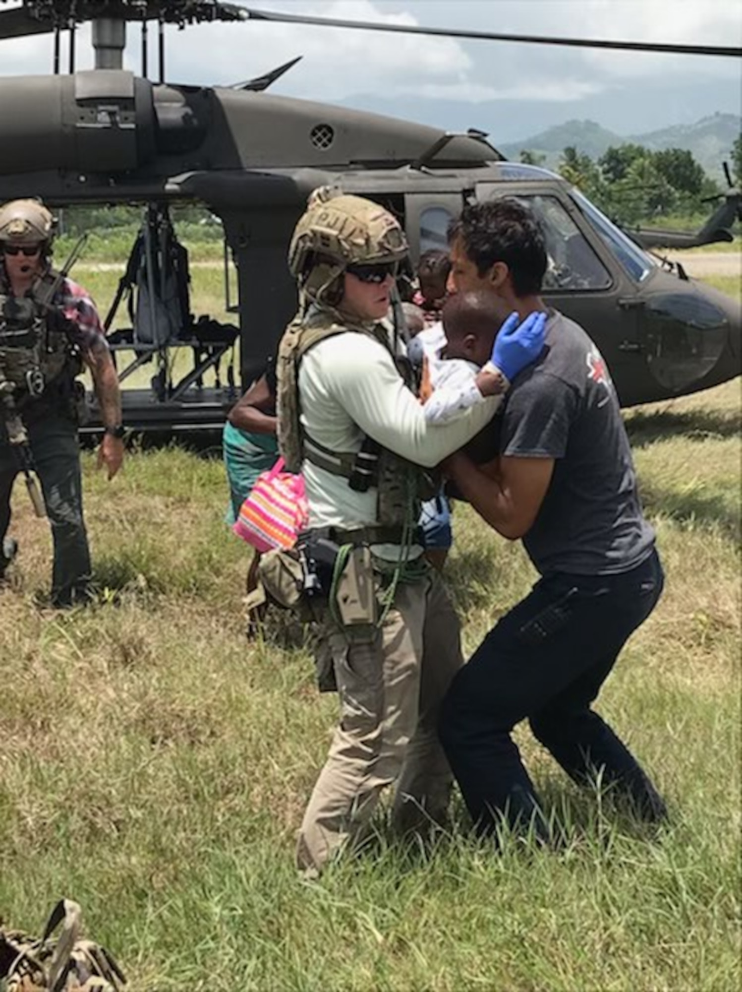 U.S. Air Force Special Tactics operator hands off an injured patient after an emergency medical evacuation in the western part of Haiti. Special Tactics Airmen responded to a request to augment Joint Task Force-Haiti relief efforts after a 7.2 magnitude earthquake hit the country Aug. 14, 2021.