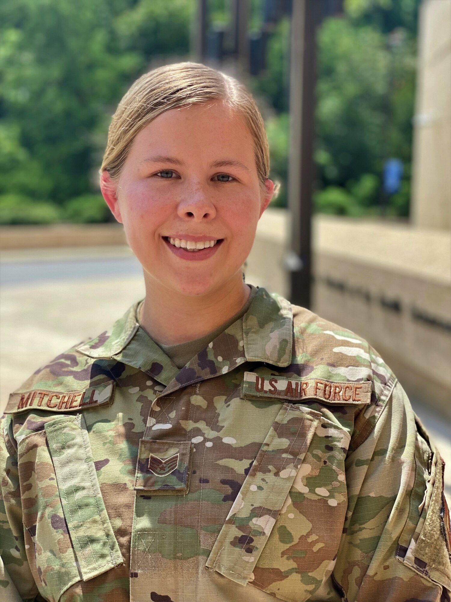 Staff Sgt. Colleen Mitchell, Air Force District of Washington Air Force Element member at the Uniformed Services University, Bethesda, Maryland, stands at the campus entrance Aug. 6. The non-commissioned officer earned a coveted place in the Department of the Air Force’s 12 Outstanding Airmen of the Year program. (U.S. Air Force photo by Master Sgt. Amaani Lyle)