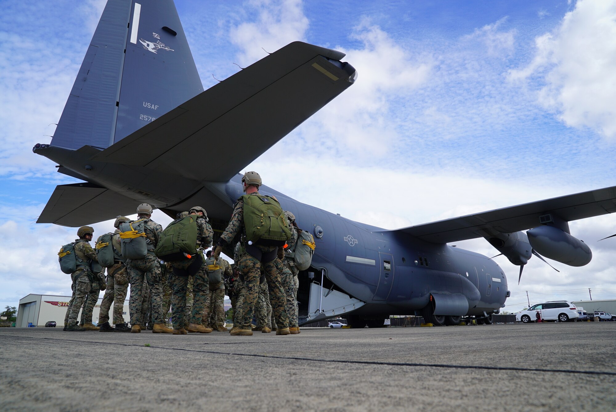 A team of Marines, Soldiers, and Airmen board an MC-130J Air Commando II assigned to the 353rd Special Operations Wing