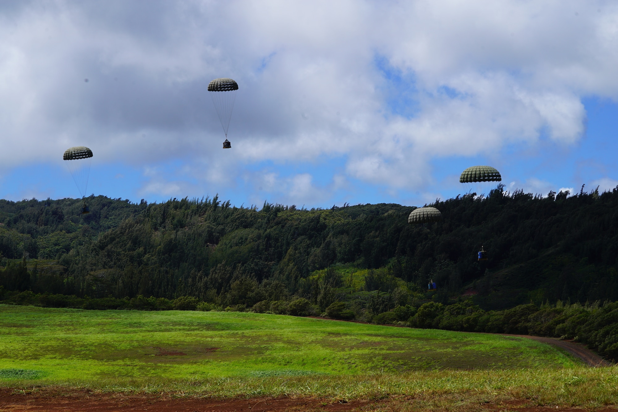 Equipment tied to parachutes drops over Kanes DZ, Hawaii