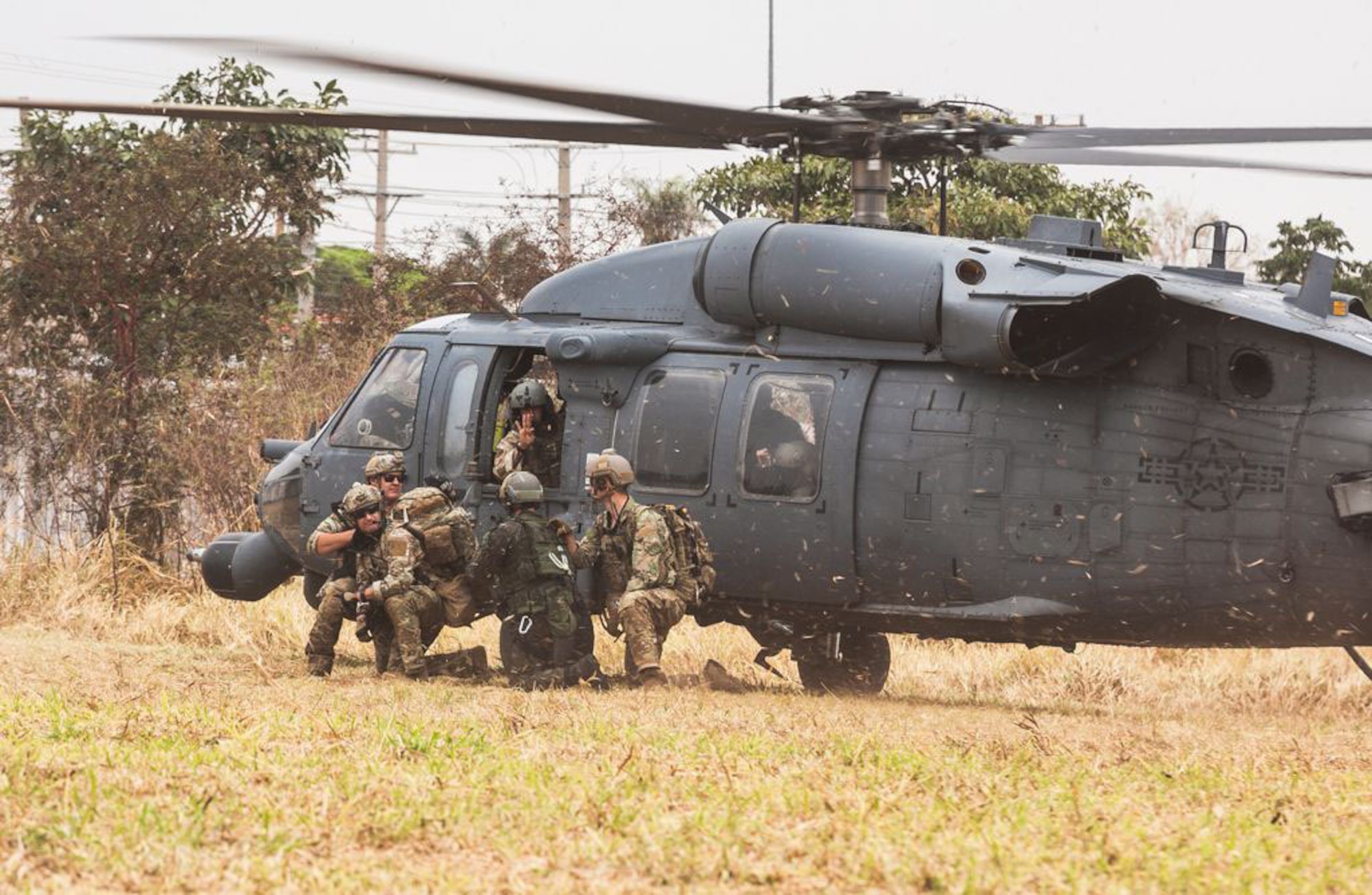 Brazilian airmen and pararescue Airmen from the New York Air National Guard's 106th Rescue Wing exit an HH-60 Pave Hawk  while participating in Exercise Tapio 2021 at Campo Grande Air Base, Campo Grande, Brazil. The exercise Aug. 19-31 was part of the National Guard's State Partnership Program.