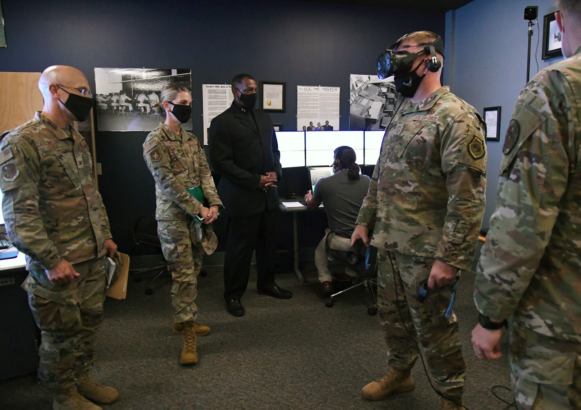 U.S. Air Force Maj. Gen. Michele Edmondson, Second Air Force commander, observes Chief Master Sgt. Adam Vizi, Second AF command chief, as he participates in a 334th Training Squadron virtual reality demonstration during an immersion tour inside Cody Hall at Keesler Air Force Base, Missisippi, Sept. 13, 2021. Edmondson toured the 81st Training Wing in order to become more familiar with its mission and capabilities. (U.S. Air Force photo by Kemberly Groue)