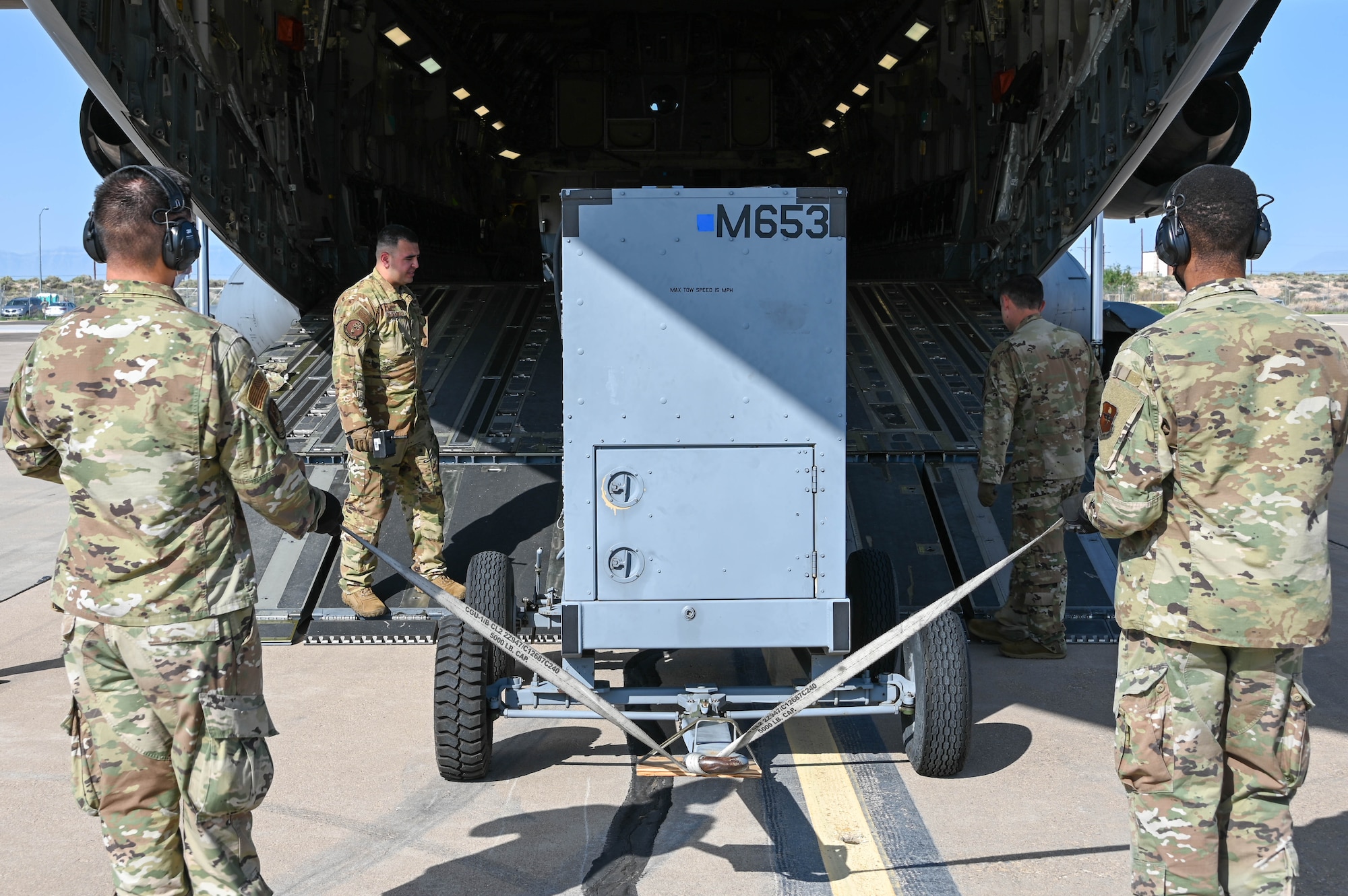 Airmen load a generator into a C-17 Globemaster III at Holloman Air Force Base, New Mexico, Sept. 9, 2021. Three generators were sent to Marine Corps Base Hawaii to support MQ-9 Reaper missions during exercise Agile Combat Employment Reaper. (U.S. Air Force photo by Airman 1st Class Kayla Christenson)