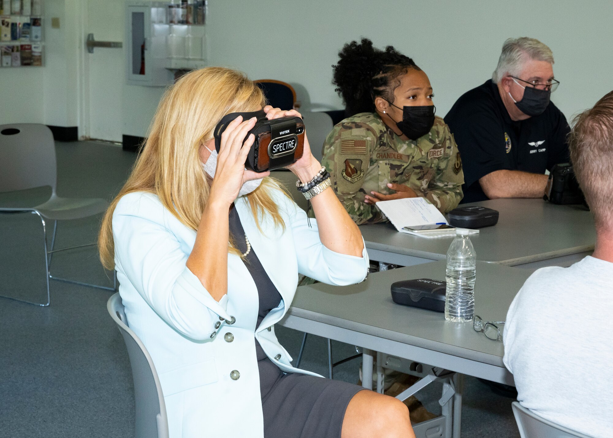 Julie Wilbanks, the Edwards AFB Community Support Coordinator, tests a virtual reality headset during a training session for "The Third Room," a software platform that allows Airmen and civilians to interface with chaplains in a remote and even anonymous manner, at Edwards Air Force Base, California, Sept. 10. (Air Force photo by Katherine Franco)